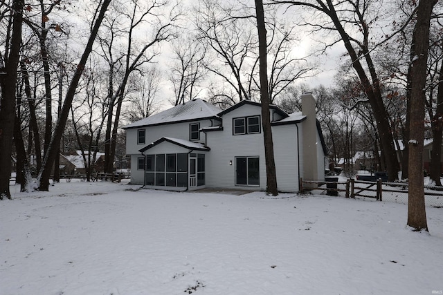 view of snow covered rear of property