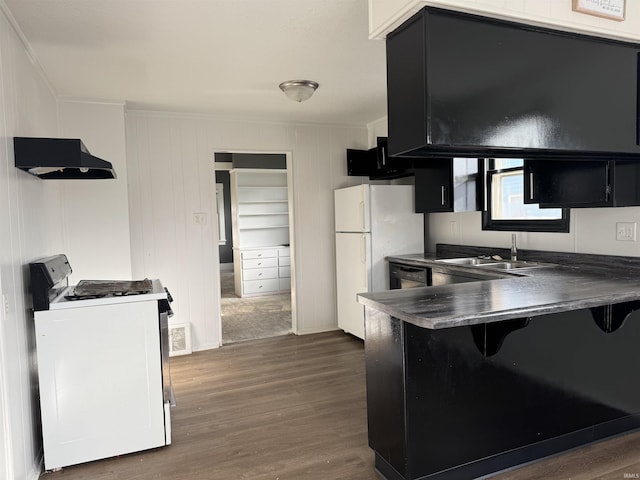 kitchen featuring kitchen peninsula, range hood, dark hardwood / wood-style floors, and white appliances