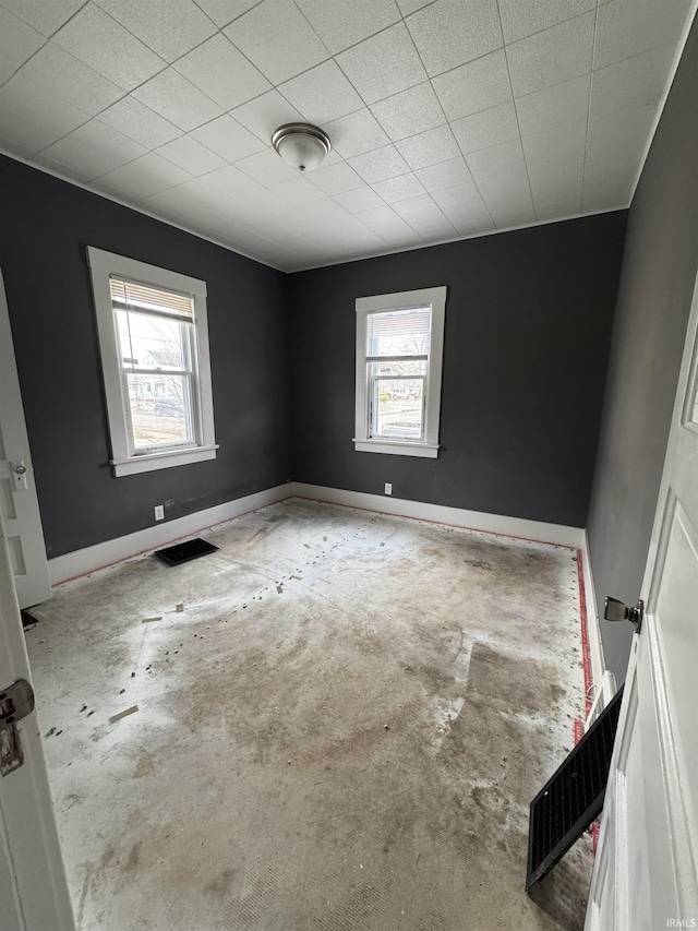 unfurnished room featuring concrete floors