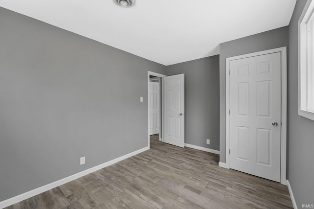 unfurnished bedroom with light wood-type flooring