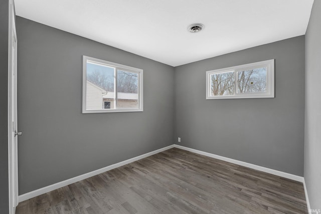 unfurnished room featuring dark hardwood / wood-style floors