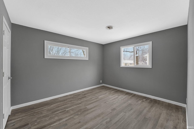 unfurnished room with hardwood / wood-style floors