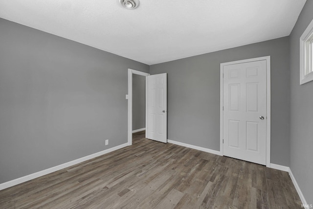 unfurnished bedroom featuring hardwood / wood-style flooring