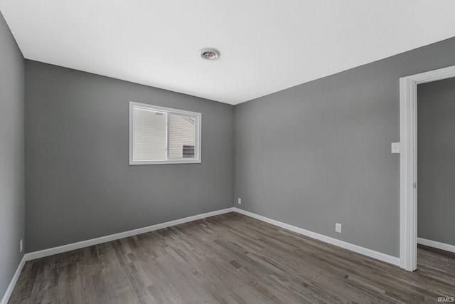 spare room featuring dark hardwood / wood-style flooring