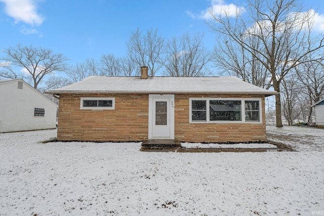 view of snow covered back of property