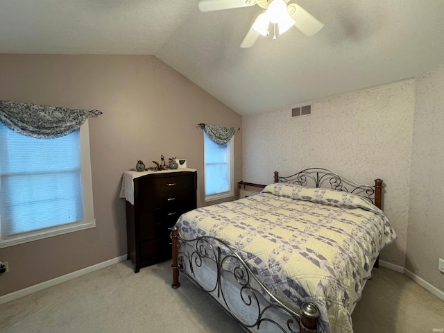 carpeted bedroom with vaulted ceiling and ceiling fan