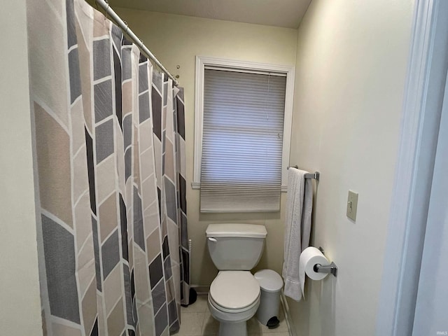 bathroom featuring tile patterned flooring and toilet