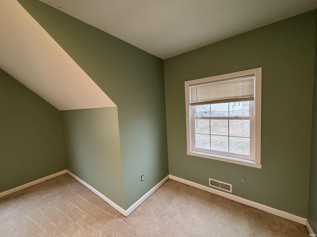 bonus room featuring lofted ceiling and carpet