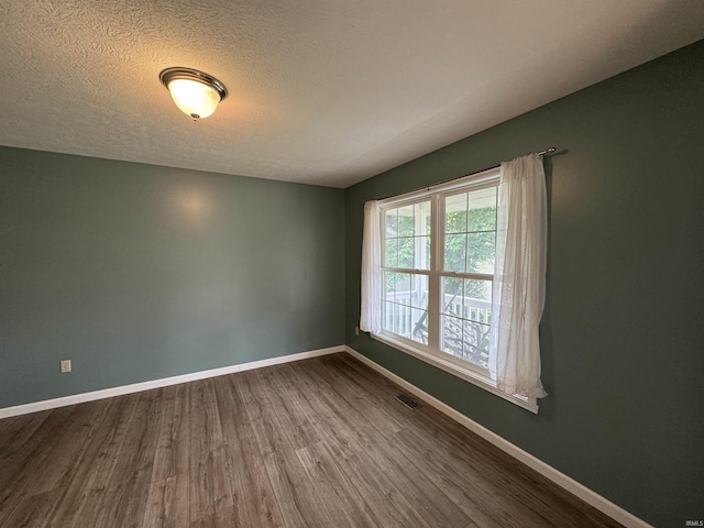 2609 S Isabel Ct, Bloomington, IN 47403 - empty room with dark wood finished floors, baseboards, and a textured ceiling
