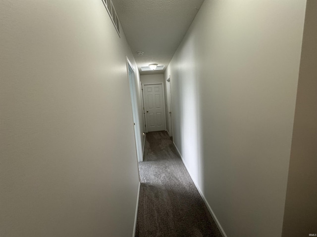 2609 S Isabel Ct, Bloomington, IN 47403 - hallway featuring dark colored carpet, baseboards, and a textured ceiling