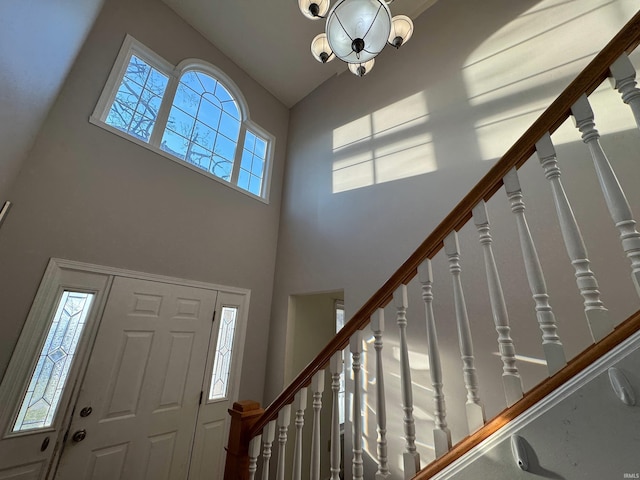 foyer featuring a chandelier and high vaulted ceiling