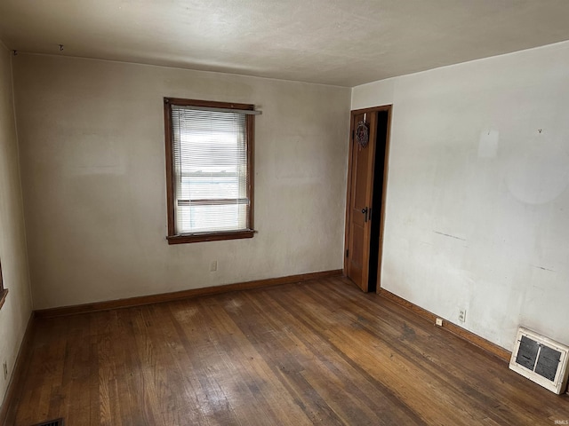 spare room featuring dark wood-type flooring