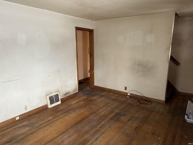 spare room featuring dark hardwood / wood-style floors