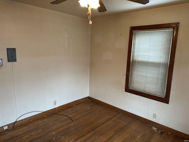 unfurnished room with dark hardwood / wood-style floors and ceiling fan