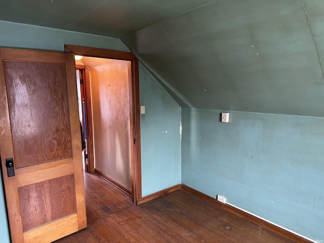 bonus room with dark hardwood / wood-style flooring and lofted ceiling