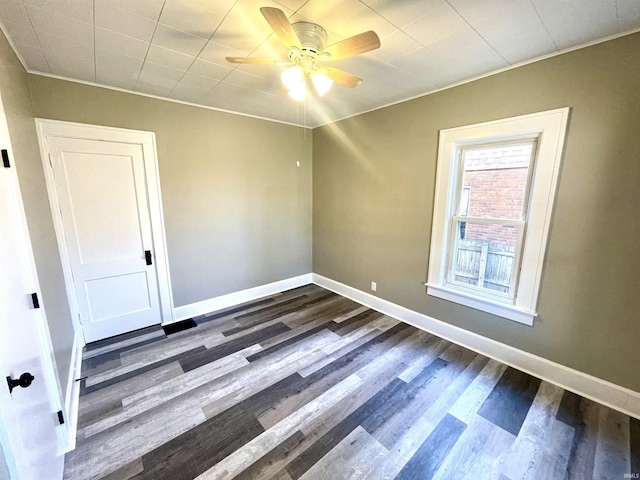 empty room with dark hardwood / wood-style floors and ceiling fan