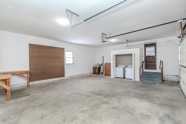 garage featuring independent washer and dryer and a garage door opener