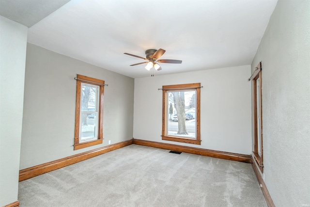 spare room with light carpet and ceiling fan