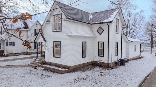 snow covered property featuring cooling unit