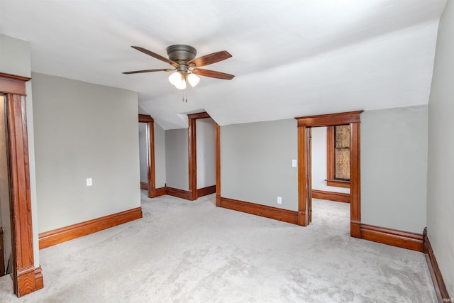 unfurnished room with ceiling fan and light colored carpet