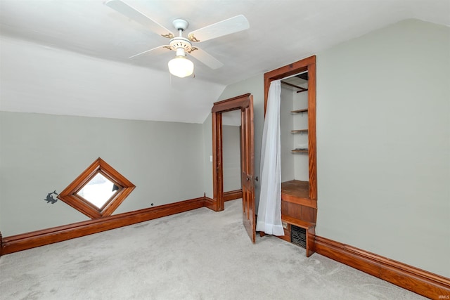 bonus room with ceiling fan, lofted ceiling, and light carpet