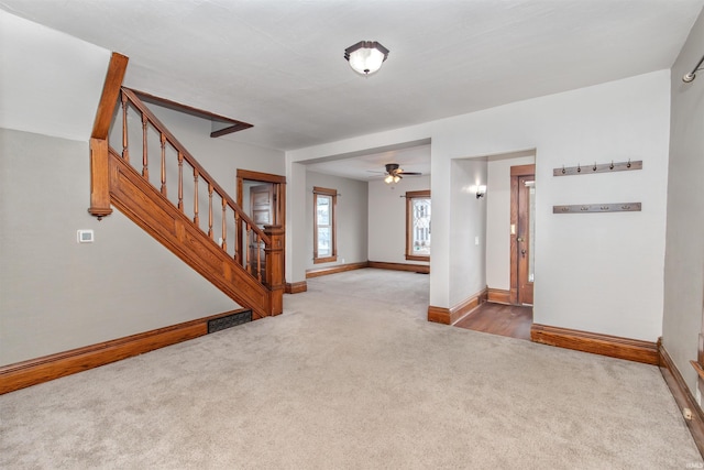 entrance foyer featuring carpet and ceiling fan