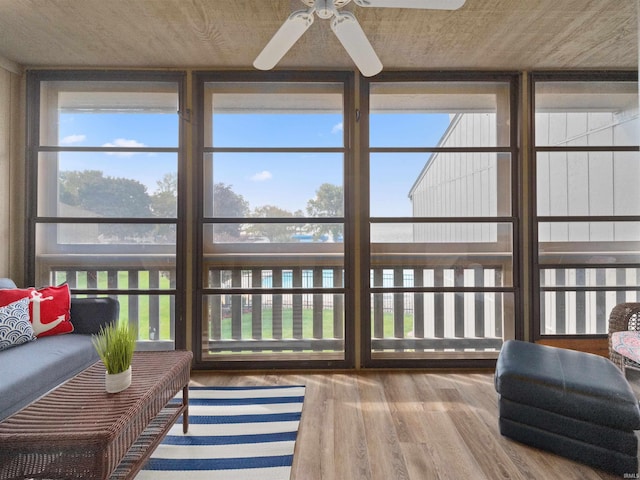 sunroom featuring ceiling fan