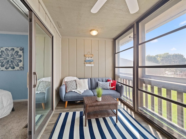 sunroom featuring ceiling fan