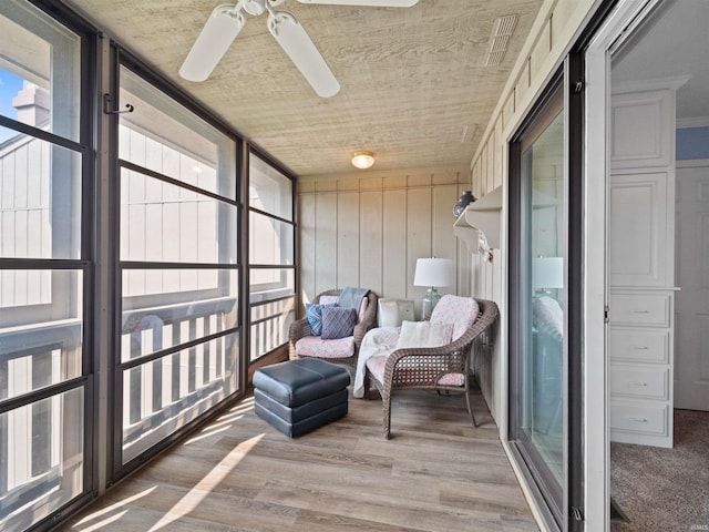 sunroom / solarium featuring ceiling fan