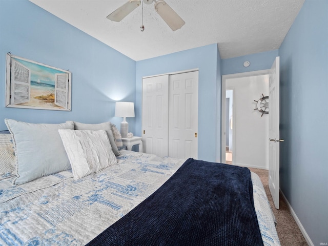 bedroom with carpet, a textured ceiling, a closet, and ceiling fan