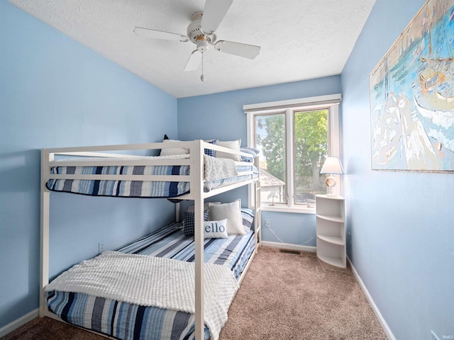 bedroom featuring carpet, a textured ceiling, and ceiling fan