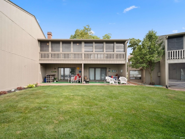 rear view of house with a patio area and a yard