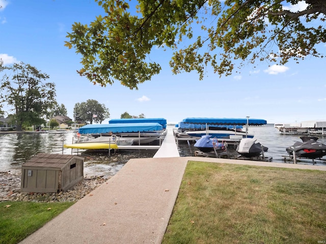 view of dock featuring a yard and a water view