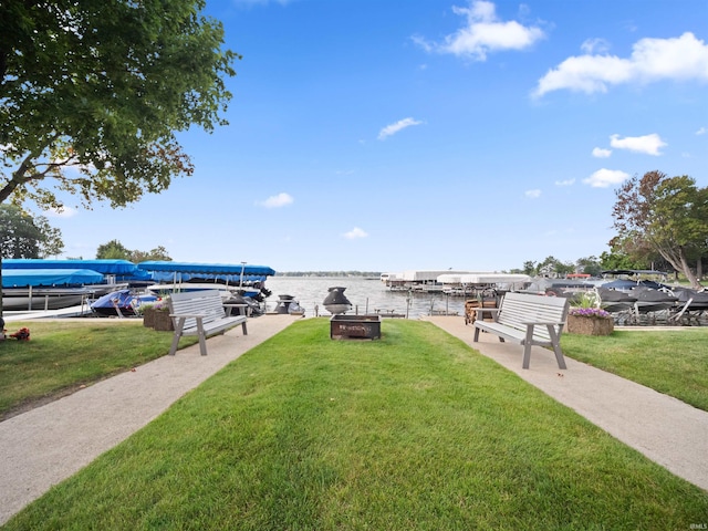 view of yard with a water view and a boat dock