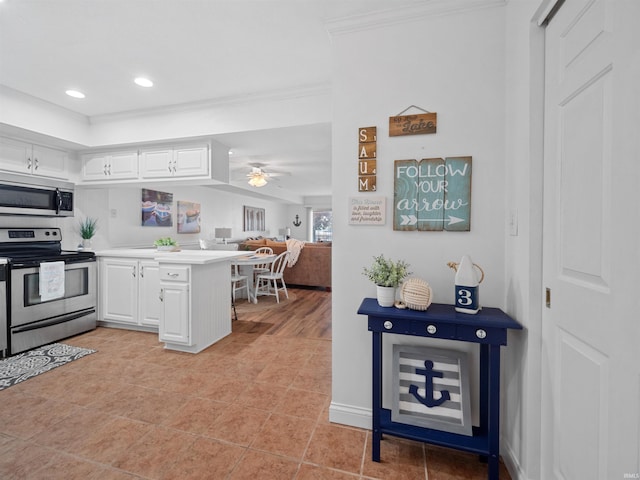 kitchen featuring white cabinetry, ceiling fan, stainless steel appliances, kitchen peninsula, and ornamental molding