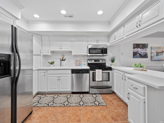 kitchen featuring white cabinetry, sink, appliances with stainless steel finishes, light tile patterned floors, and ornamental molding