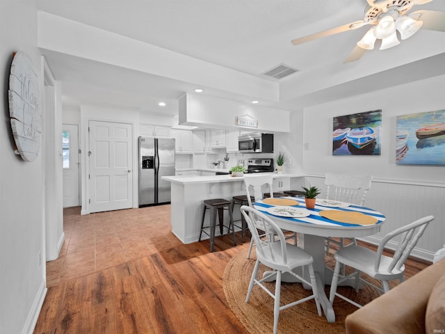 dining space featuring ceiling fan and light hardwood / wood-style floors