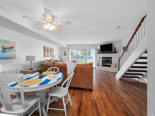 dining room with ceiling fan and dark wood-type flooring