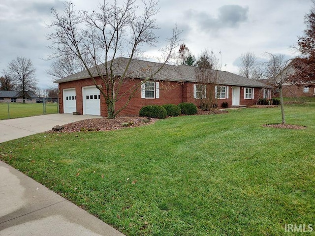 ranch-style home with a garage and a front lawn