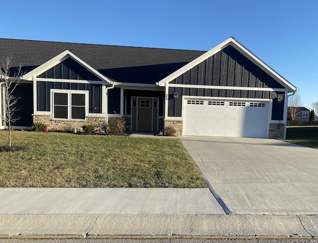 view of front of house with a front yard and a garage