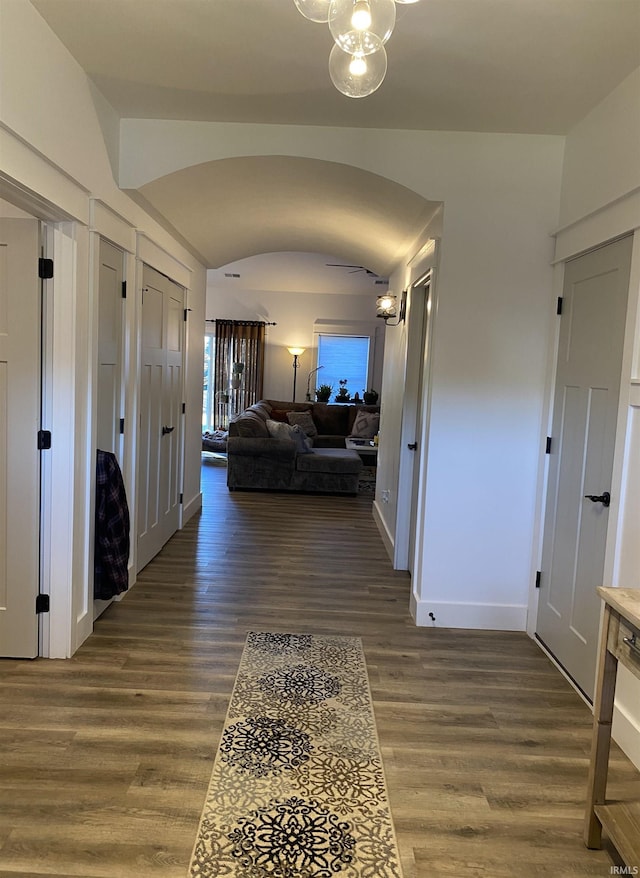 corridor with dark hardwood / wood-style flooring