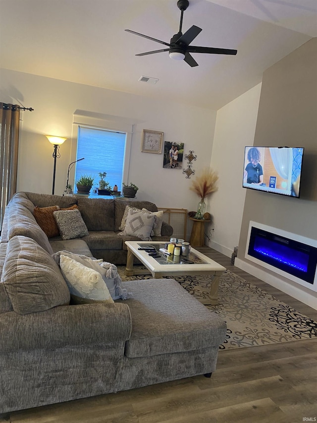 living room with ceiling fan and wood-type flooring