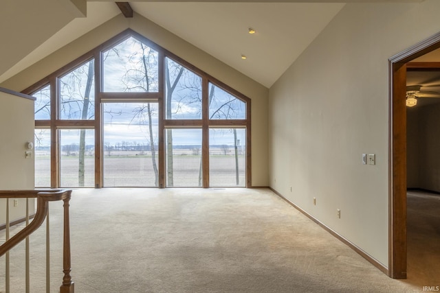 unfurnished living room featuring light colored carpet and high vaulted ceiling