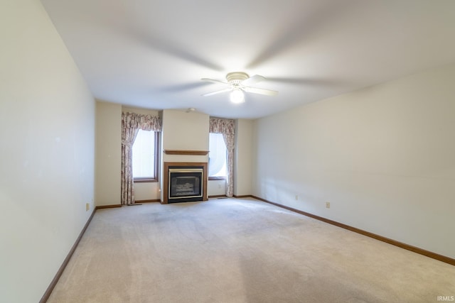 unfurnished living room featuring ceiling fan and light colored carpet