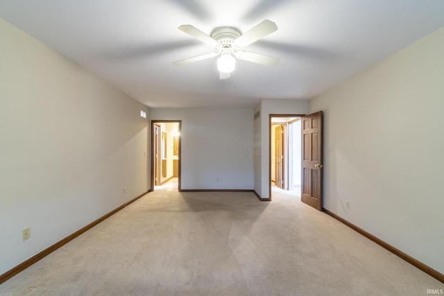 spare room featuring ceiling fan and light carpet