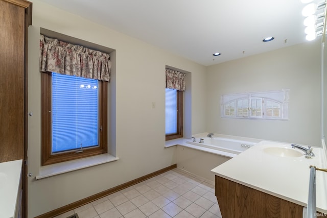 bathroom with tile patterned flooring, vanity, a bathtub, and a wealth of natural light