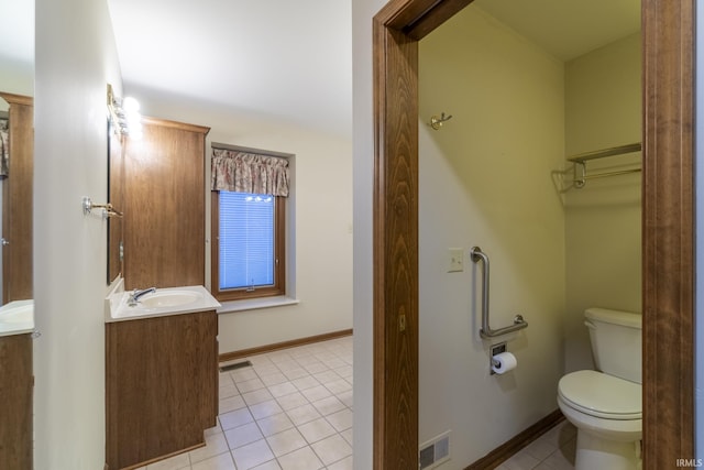 bathroom with tile patterned floors, vanity, and toilet