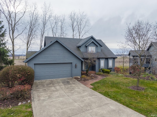 view of front of house with a garage and a front lawn