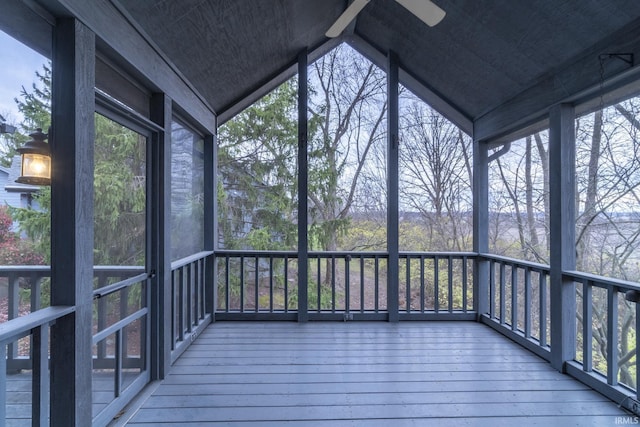 unfurnished sunroom featuring ceiling fan and vaulted ceiling