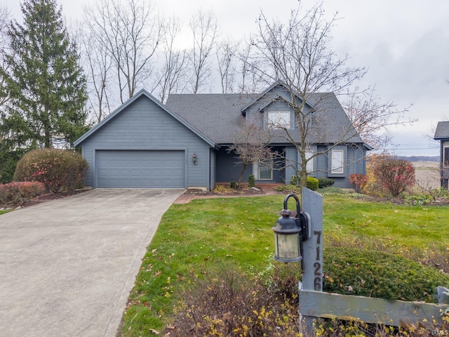 view of front of property featuring a front yard and a garage